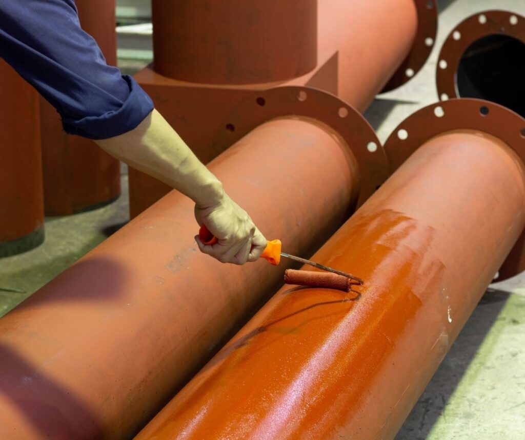 Rust-proof painted steel pipes in the factory. Red iron pipe
