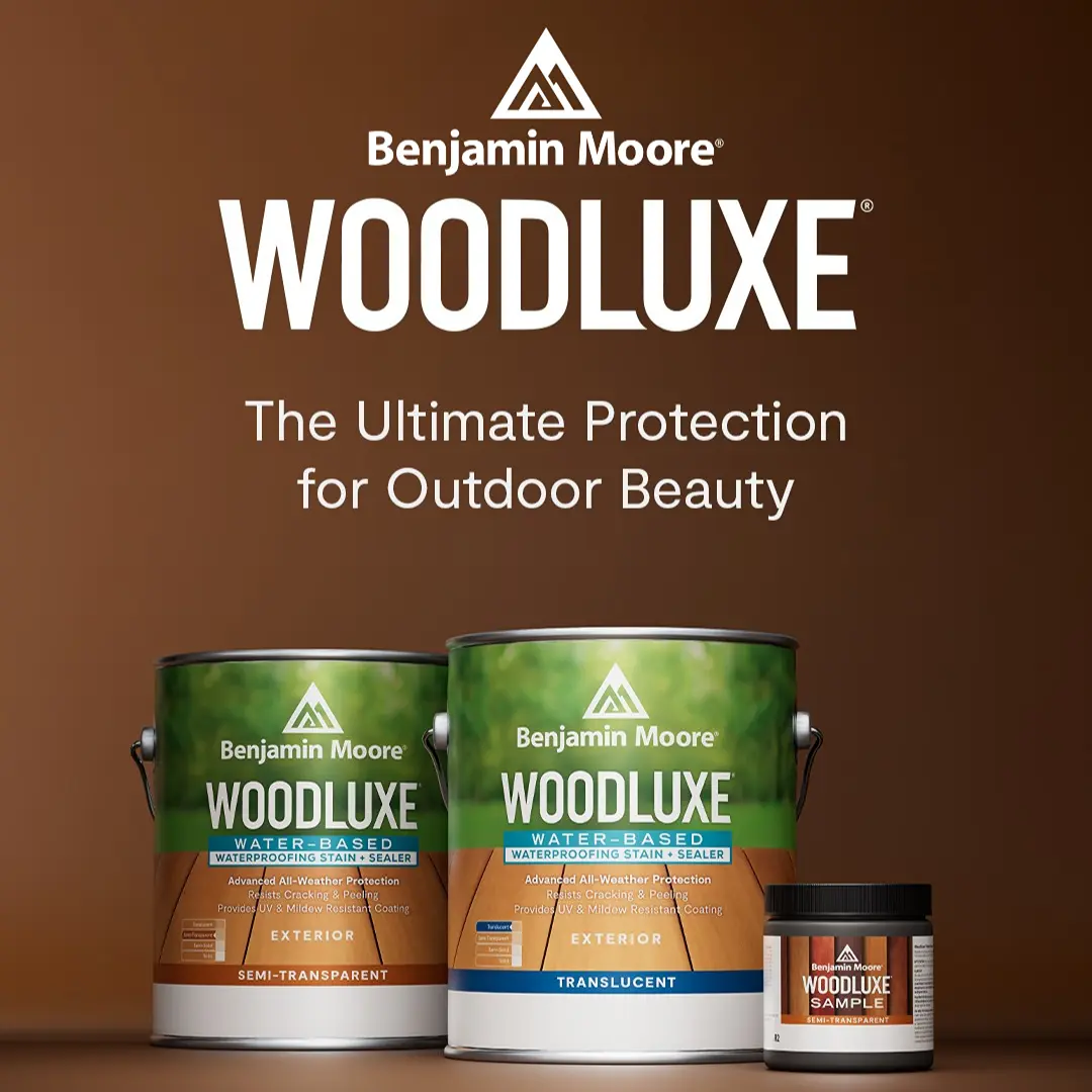 Person staining wood with brush