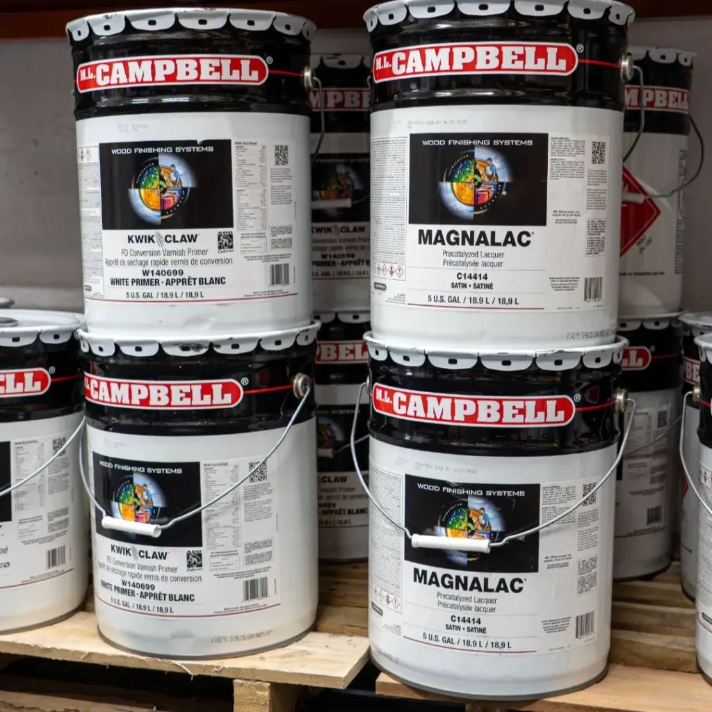 Buckets of paint stacked on shelves.