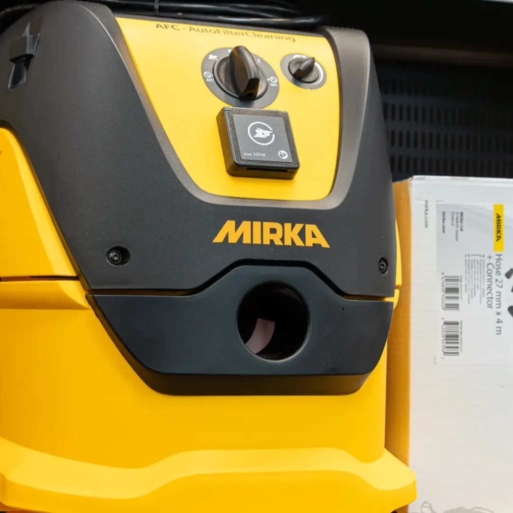 Buckets of paint stacked on shelves.