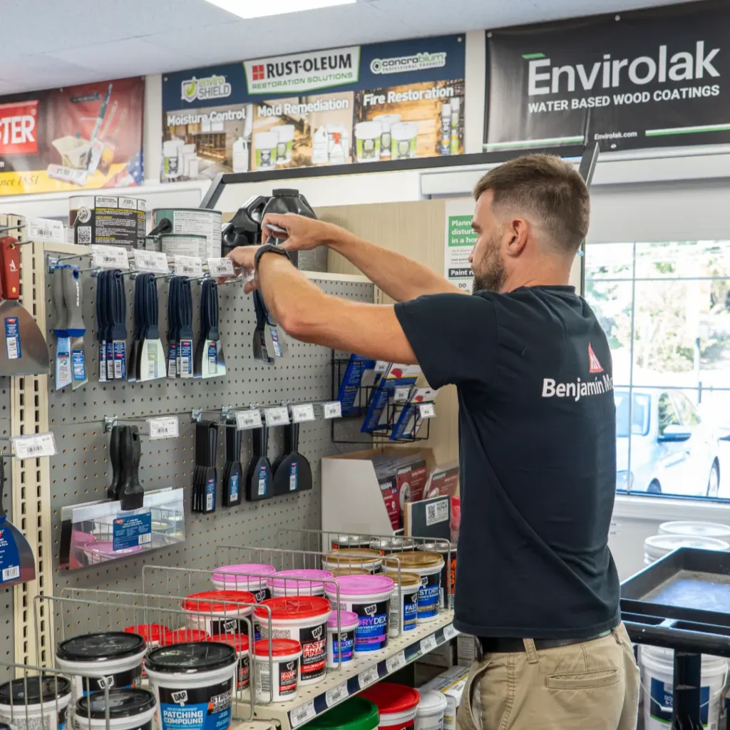 Man organizing tools in store