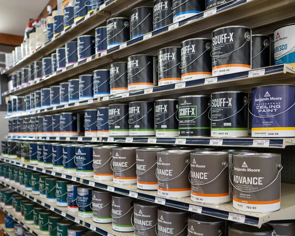 Shelves filled with Benjamin Moore paint cans.